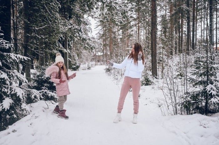 Mother-daughter snow play.