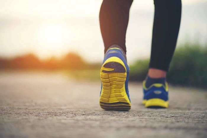 Limping while walking.
