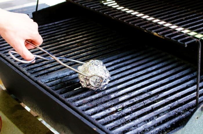 Cleaning Barbecue with Hot Water and Foil